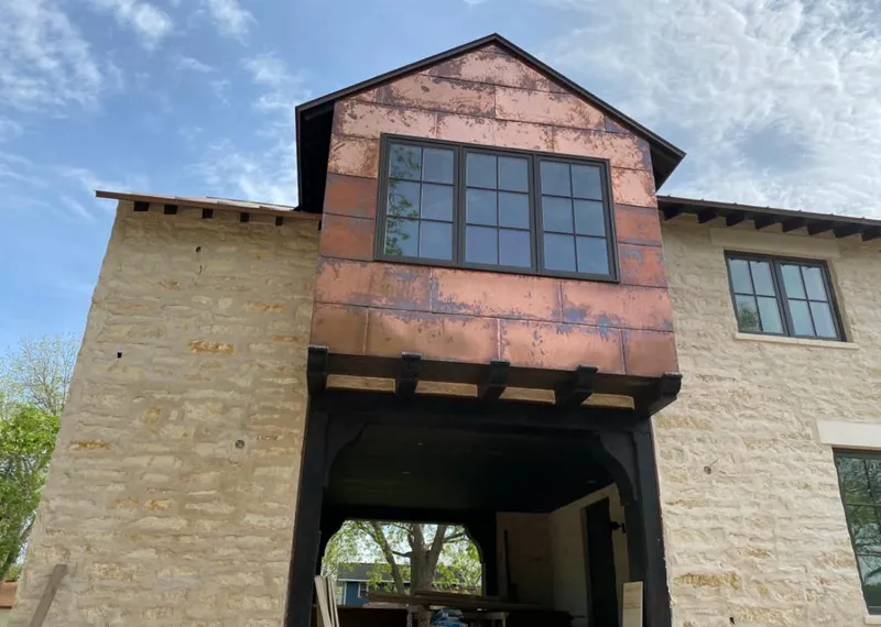 Copper metal panel facade on a stone building for Skylight Installation in Lorton